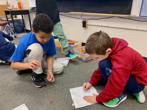 Using dice to solve a math problem in grade 3 at Mariposa Elementary School.