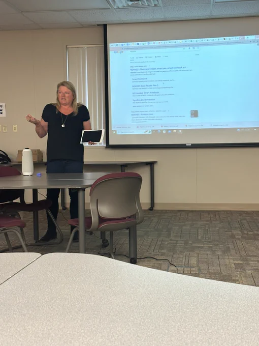 Andrea presenting on an LED writing tablet to support individuals