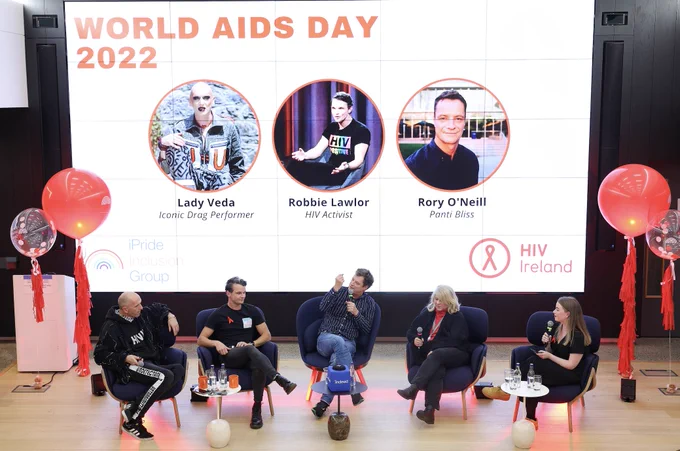 Five person panel sitting in front of presentation screen.