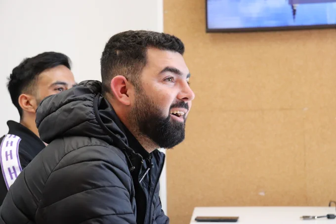 Refugee smiling and being helped by Progress in Coventry