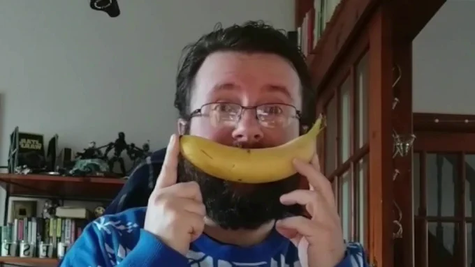 Les using a banana for a comedy smile.