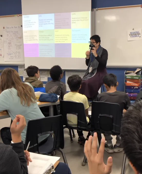 Kimiko speaking with a classroom of students.