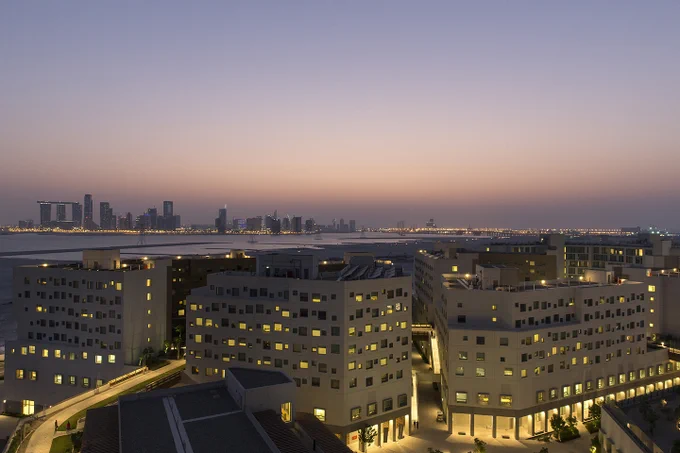 Photo of New York University Abu Dhabi from above, the city of Abu Dhabi in the background.