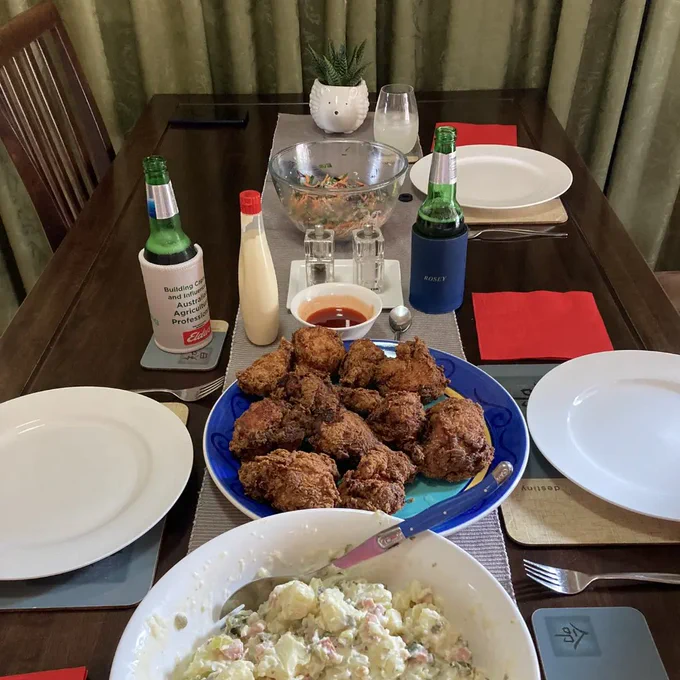 A table with fried chicken and salads
