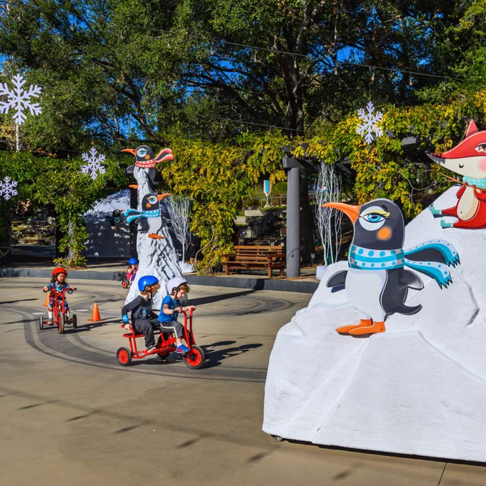 Children riding trikes on track