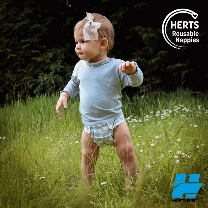 child outdoors wearing reusable nappy