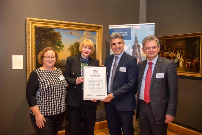 A group of representatives holding the award certificate.