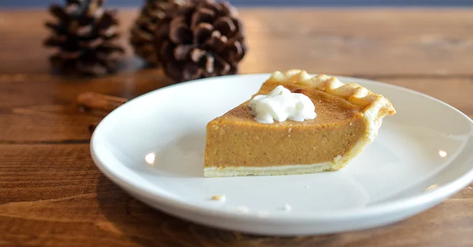 slice of pumpkin pie on a white plate