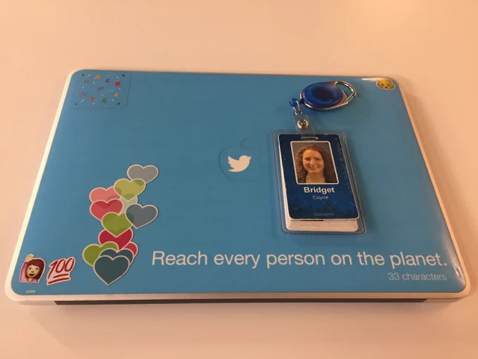 Bridget's Twitter laptop and ID badge with a sticker that repeats one of the company's core values "Reach every person on the planet" and other fun stickers like Periscope hearts