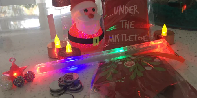 Christmas products containing button batteries including a santa decoration, festive tea lights and a flashing wand