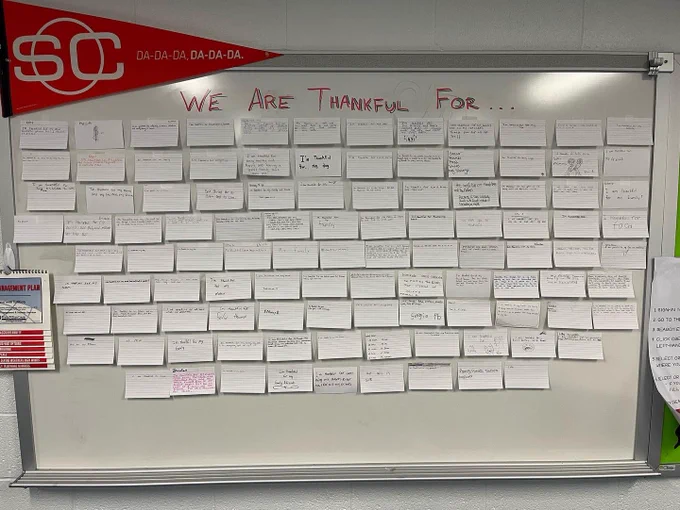 Whiteboard that says “We are thankful for…” and index cards with student responses.
