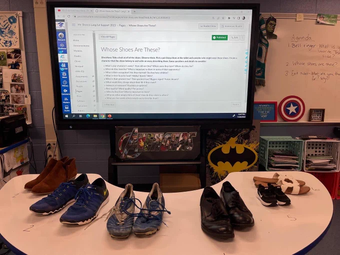 Horseshoe table with six different pairs of shoes.