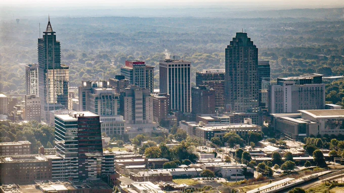A view of the Raleigh skyline from above on a sunny day.