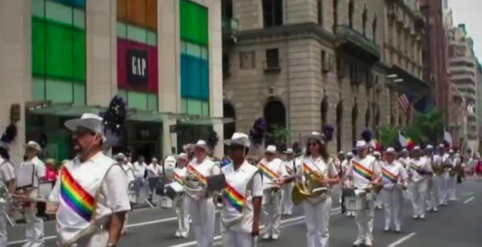 Band with rainbow bands on their chest