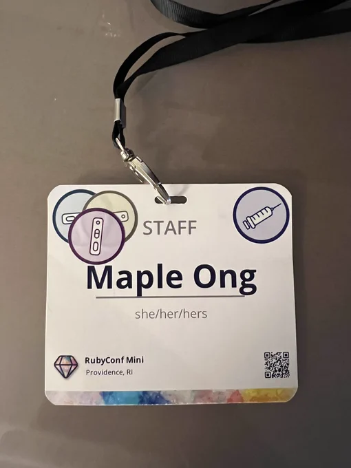 Maple’s conference badge containing the appropriate amount of sticker indicating negative COVID tests.