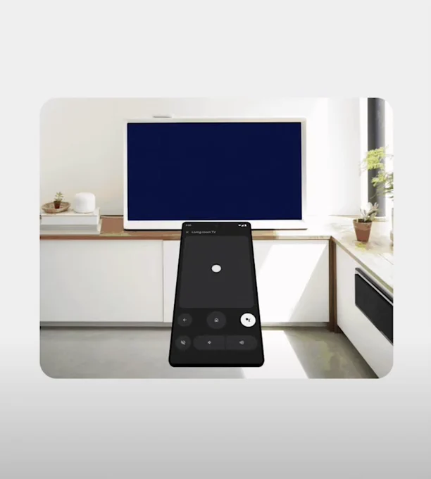 Phone pointing toward a TV with a remote app open and ready 