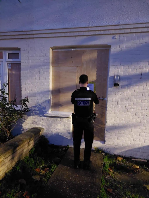 The photo shows a member of Suffolk Constabulary putting the court order up at the address