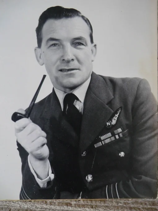 Old photo of Johnny, smoking a pipe in RAF uniform after the war