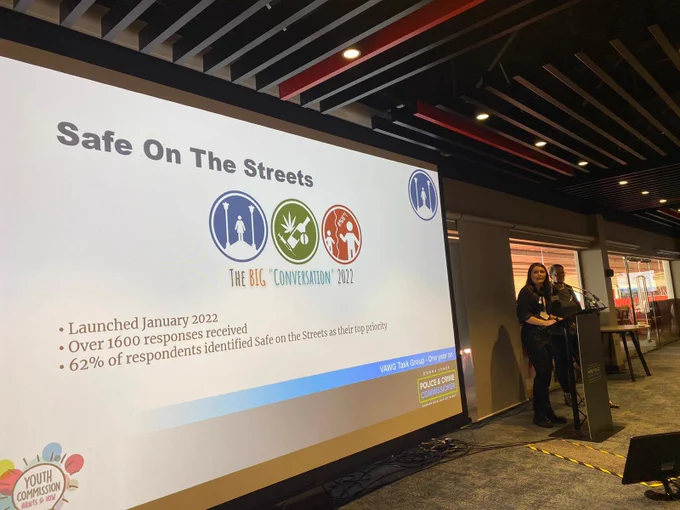 Member of the youth commission presenting slide showing logos of safe on the streets, substance misuse and hate and hostility