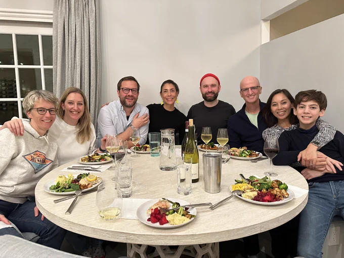 A group of Working Out Loud drivers enjoying dinner together sitting around the table with great food