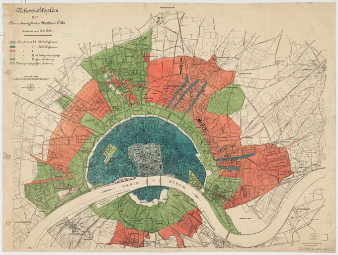 map of the city with the river running through it horizontally. Land-use areas appear in blue (ciy center), green, and red. 