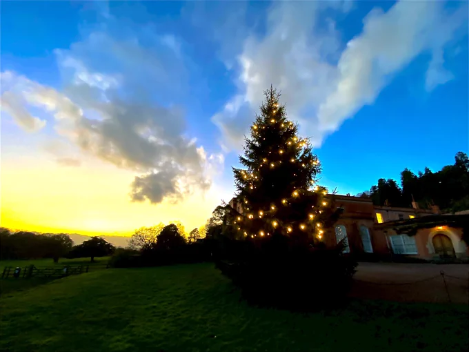 The lit up Christmas tree outside the from of Killerton House. Taken during the Meridian Raw CIC Chasing with Cameras Photo-walk, which captured the houses Christmas preview. 26th November 2022.