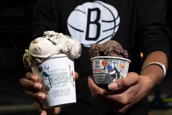 A photo of someone holding both of the new birthday cake ice cream flavors