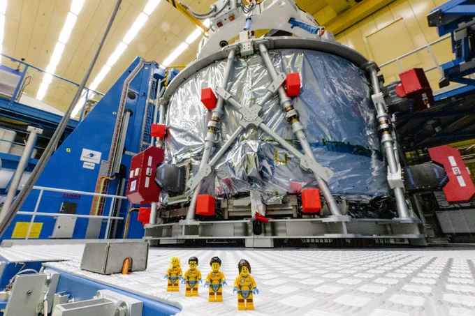 Representative LEGO minifigures in front of European Service Module that will power the Orion spacecraft on Artemis II. Four LEGO minifigures will fly on Artemis I as part of the official flight kit, which carries mementos for educational outreach and posterity. 