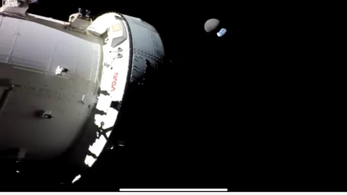 The Orion spacecraft, the Moon, and Earth as seen from a camera at the end of one of Orion's solar panels. Credit: NASA