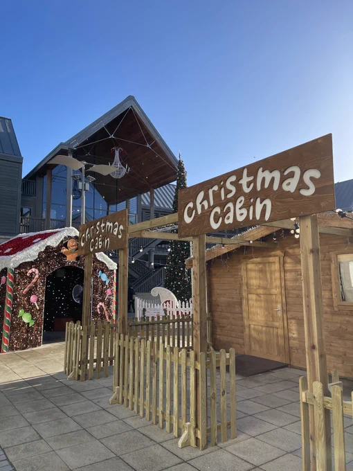 The Apex building with Christmas cabins in front.