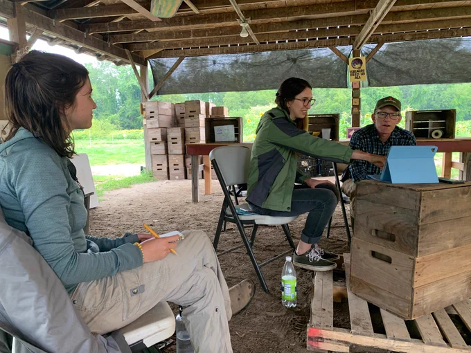 A researcher giving a presentation to a farmer