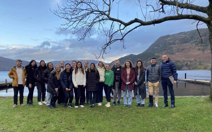 Group of students from the BHF programme in front of a lake