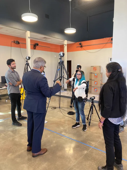 NSF-funded students demonstrate share their research on exoskeleton robotics assisting humans with NSF Director Panchanthan.