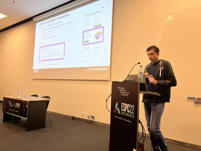 Presenter standing behind a podium and showcasing the different experiences on Viva Connection