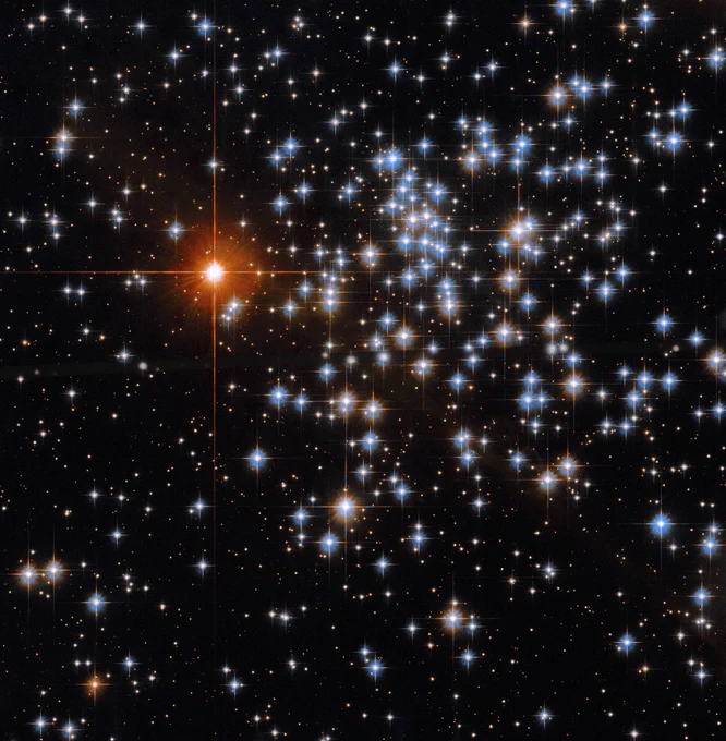 Several stars with pointed diffraction spikes gleam in shades of white, orange, and blue against a black backdrop of space.