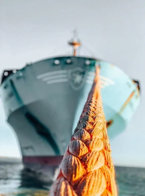orange rope towing large vessel