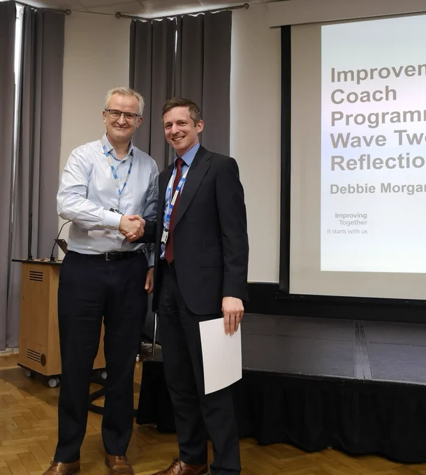 Certificate being awarded with handshake