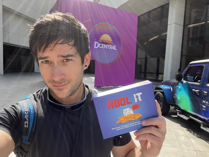 Marty holding a box of Hodl It at the Dcentral entrance