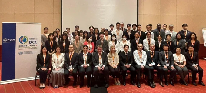 WHO Global Outbreak Alert and Response Network (GOARN) members pose for a group photo during the International Outbreak Response workshop in Tokyo, Japan

Photo shows a group of people seated and standing, smiling at the camera next to a tarp
