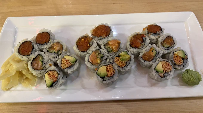 A platter of spicy salmon and spicy tuna sushi