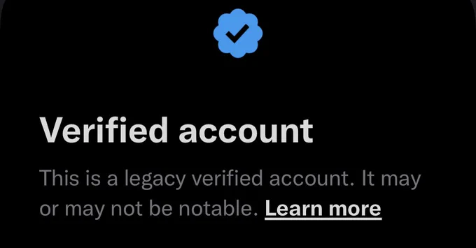 Pop up from Twitter app that shows a blue check mark and says “Verified account. This is a legacy verified account. It may or may not be notable.”