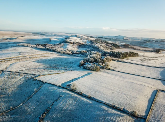 A snowy Magna Fort with Walltown Crags beyond (c) Vindolanda Trust