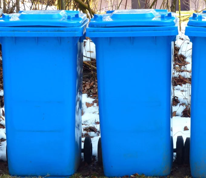 Blue wheelie bins in snowy/icy conditions