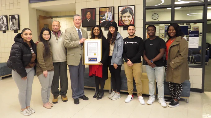 President Barry Maloney is pictured with OMA Director Laxmi Bisoondial, Robert Jennings and students from the OMA program in the lobby of the LRC.