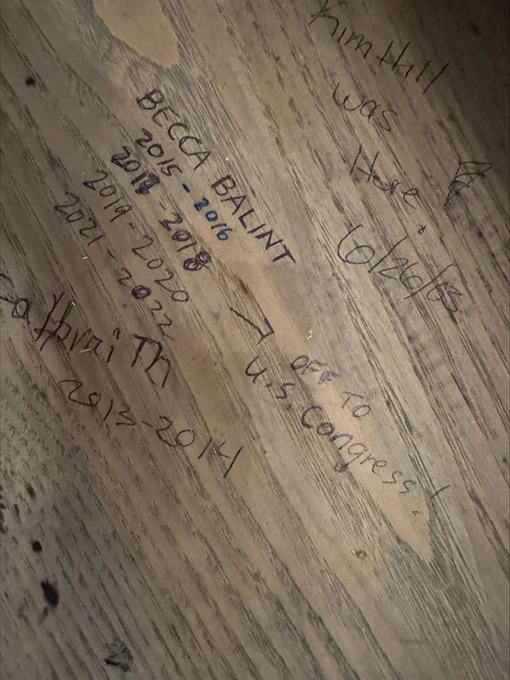Written inside of wooden desk: Becca Balint's name, years in VT senate, and the phrase "Off to U.S. Congress!"
