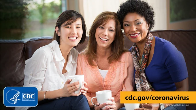 Graphic with three people sitting on a couch drinking coffee with text overlay cdc.gov/coronavirus. Graphic is branded with CDC and HHS logos.