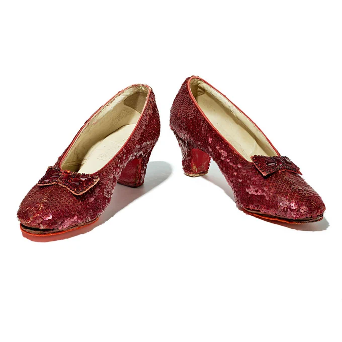 Well-worn low kitten heels with bow, covered in ruby sequins.