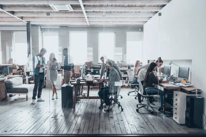Open concept office space with multiple people working on computers