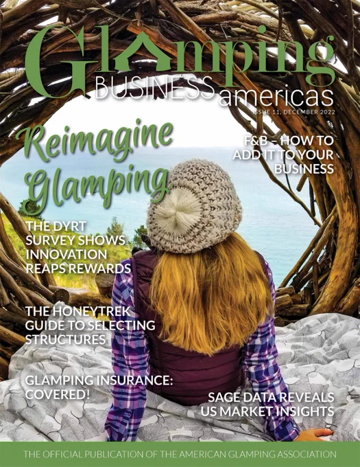 The front cover the December issue of Glamping Business Americas features a woman looking out at the ocean from the circular opening of a wooden glamping structure. The stories teased are: F&B How to Add it to your Business, The Dyrt Survey Shows Innovation Reaps Reward, The Honeytrek Guide to Selecting Structures, Glamping Insurance: Covered! and Sage Data Reveals US Market Insights.