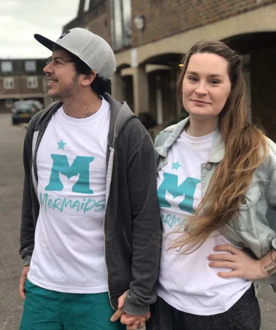 Fox and Owl hold hands and wear T-shirts with the mermaids logo
